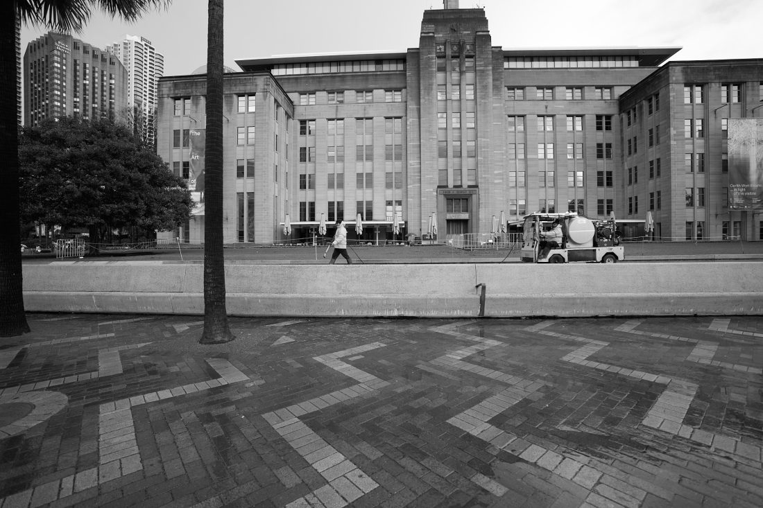 A department of public works employee cleaning the street.