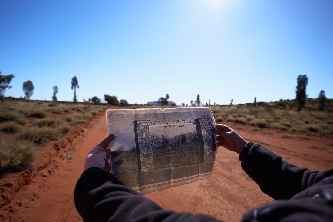 A tour guide shows the newspaper ad for a resort that resided on indigenous lands.